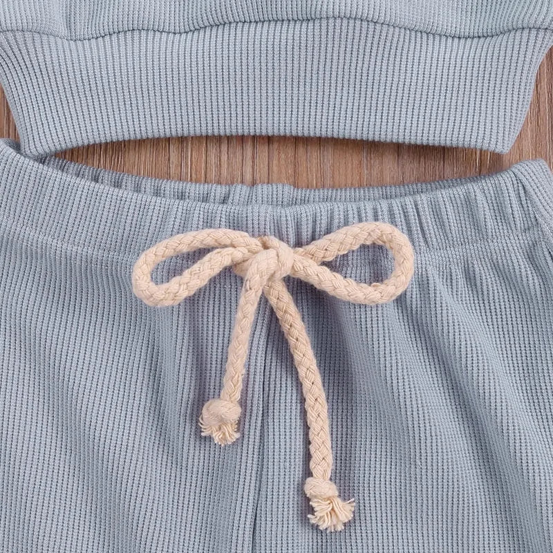 Side view of the rainbow embroidered baby set